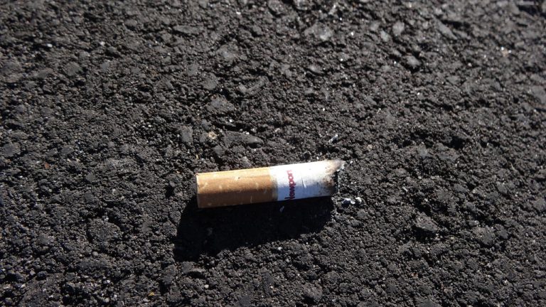 Tossed lit cigarette butt led police to discover house arrest violation
