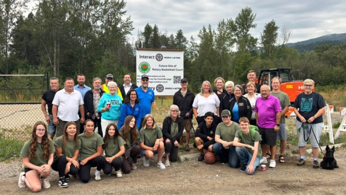 This is a photo of the Castlegar Rotary Club breaking ground on a new outdoor basketball court at Millennium Park.