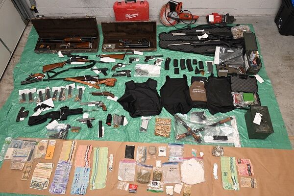 Photo of guns, cash and stolen items from Warfield bust.